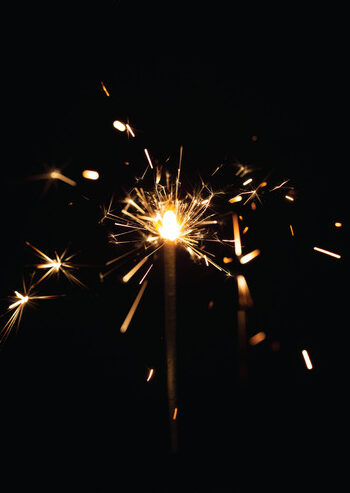 This image shows a burning sparkler, a handheld firework commonly used for celebrations.